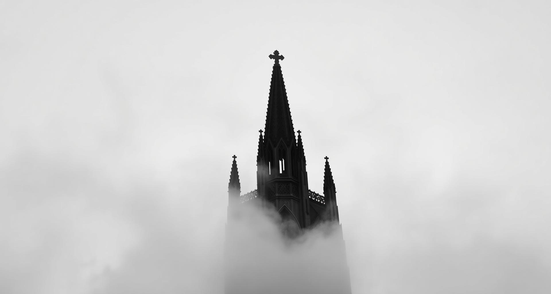 Cathedral spire emerging from the mist